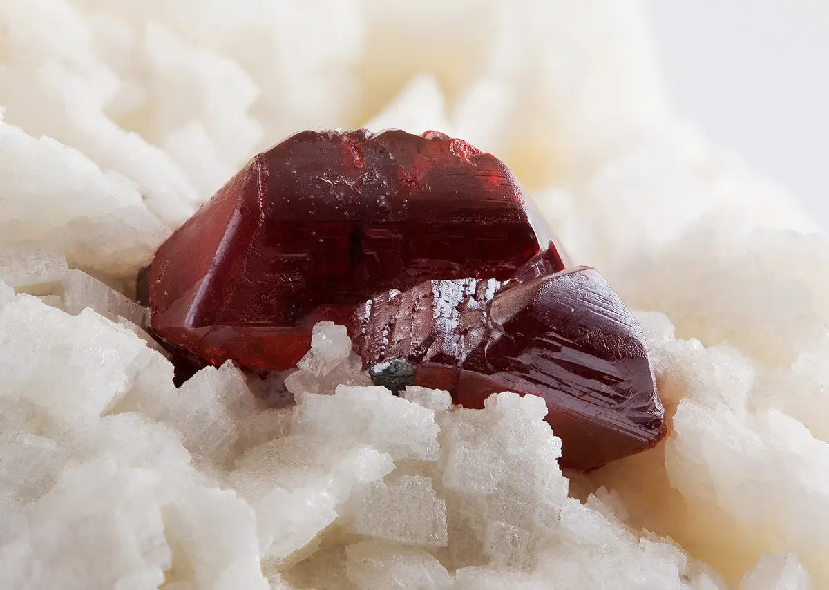 A specimen of cinnabar: bright red crystals of mercury sulfide on a pale dolomite matrix.
