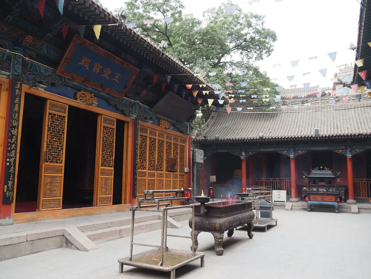 Courtyard and halls of the White Cloud Temple in Beijing, with incense burners and tiled roofs.