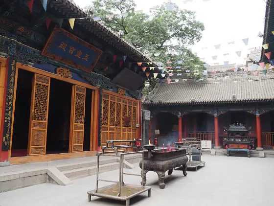 Courtyard and halls of the White Cloud Temple in Beijing, with incense burners and tiled roofs.