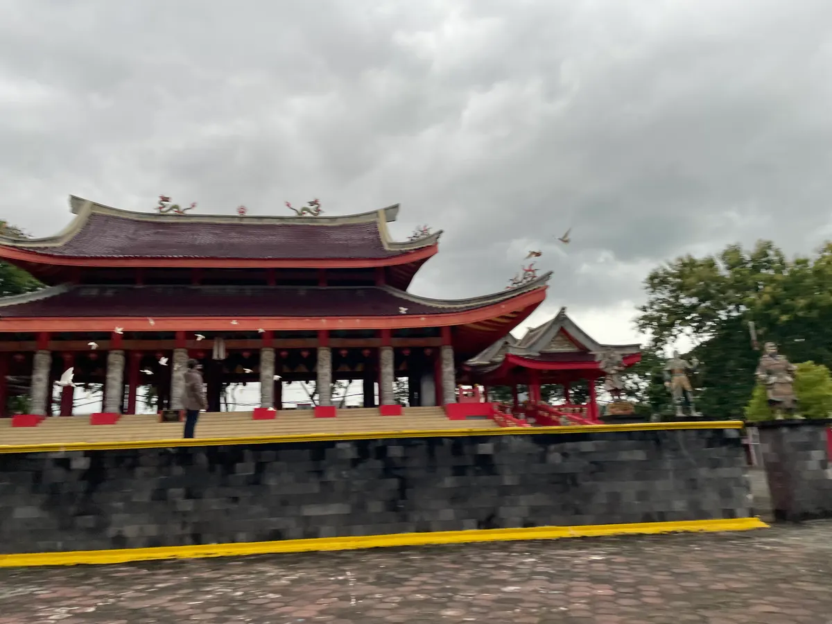 The Sam Poo Kong temple in Semarang: red and gold Chinese temple buildings under a wide sky.