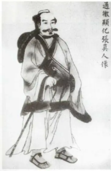 Traditional ink portrait of Zhang Sanfeng, a bearded Taoist in robes carrying a staff.